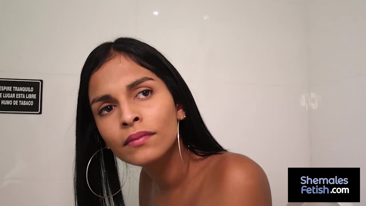 Beautiful shemale Jessi Martinez blowing dick at gloryhole